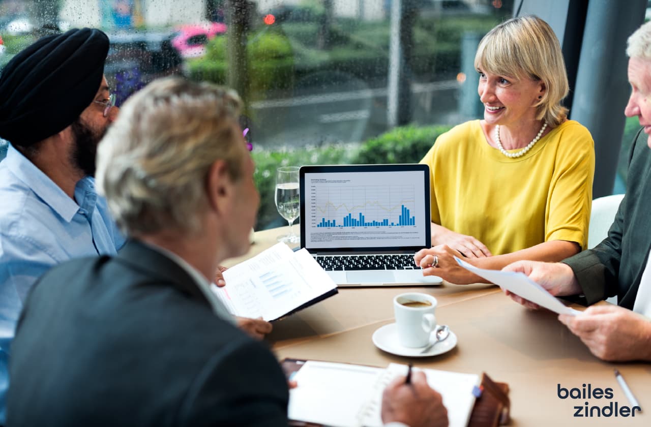 Financial professional reviewing a modern website interface on a laptop, representing Bailes + Zindler financial website design