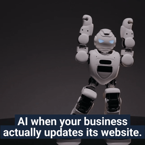 Small white humanoid robot throwing its arms up in celebration with the caption “AI when your business actually updates its website,” representing how AI systems reward fresh updates and clean website structure.